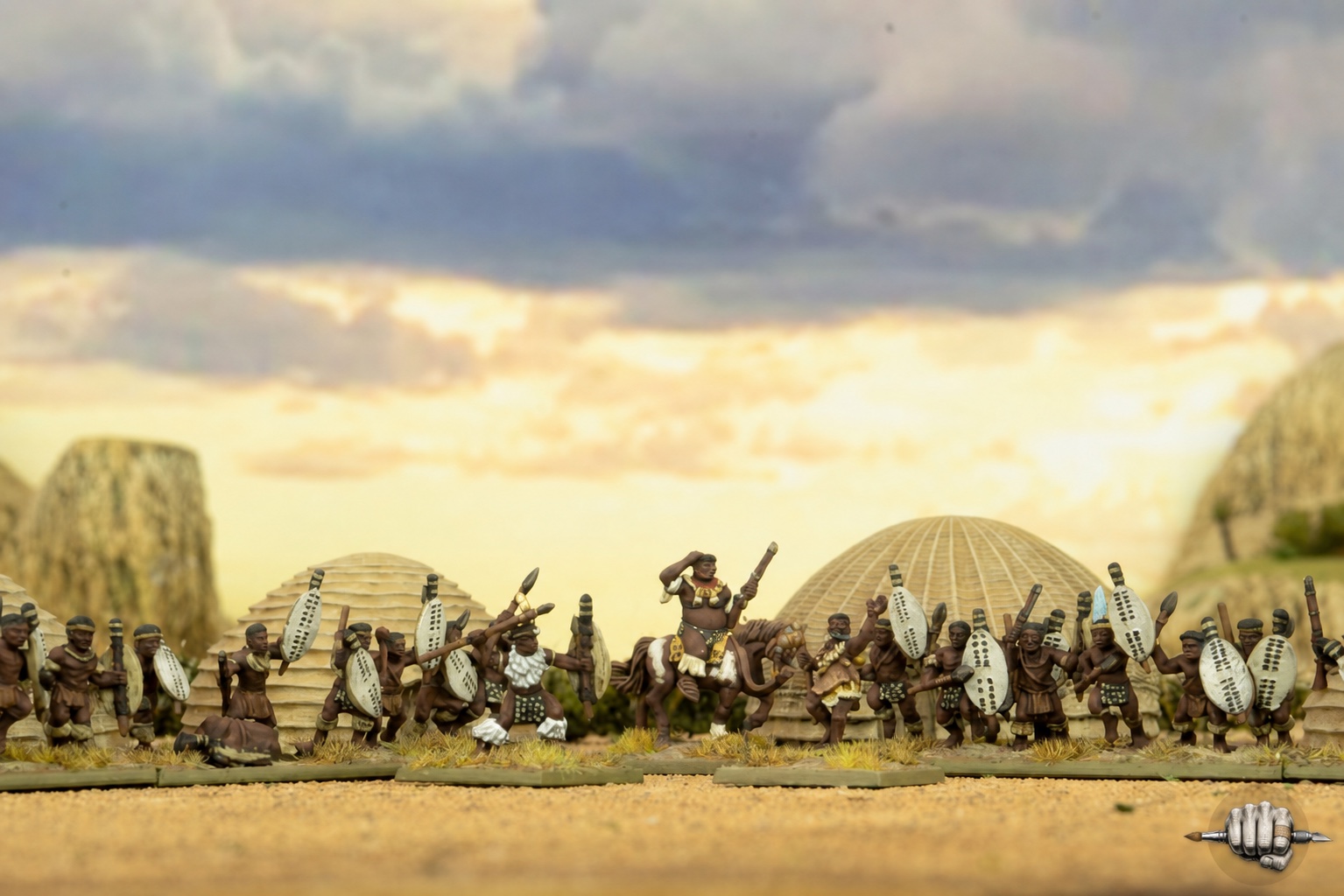 Painted Epic Battles Zulu warriors assembled in front of model homesteads